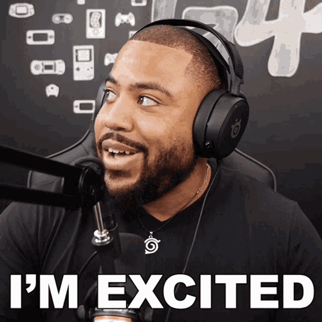 a man wearing headphones says " i 'm excited " in front of a microphone