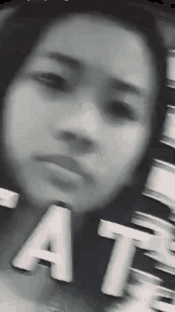 a close up of a woman 's face with the word fat in the background