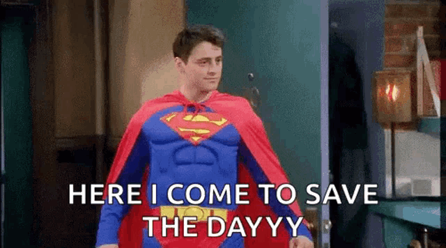 a man in a superman costume is standing in front of a door and saying here i come to save the day .