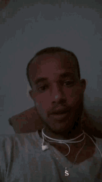 a man wearing headphones and a shirt that says ' s ' on it