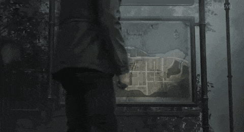 a man is standing in front of a map of a city in the fog .