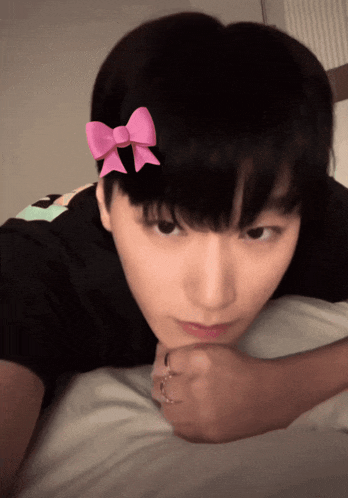 a person wearing a pink bow on their head