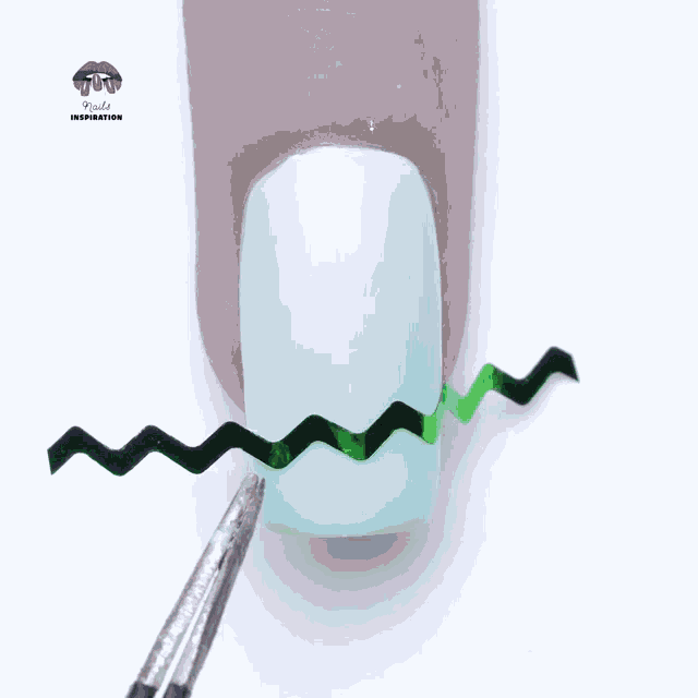 a close up of a nail with a brush and the words nails inspiration on the bottom left