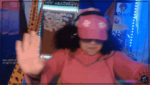 a girl wearing a pink hat and sunglasses is standing in front of a sign that says happy halloween