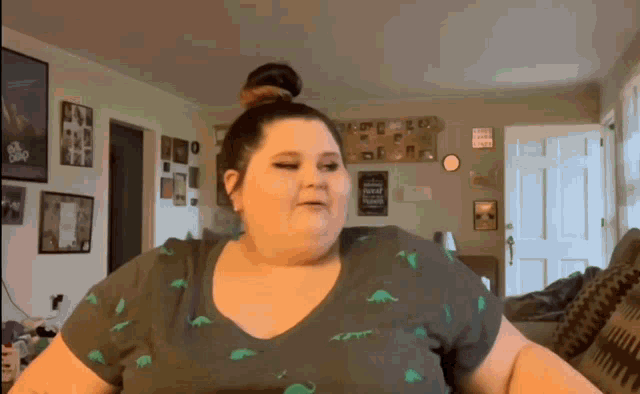 a woman wearing a t-shirt with dinosaurs on it