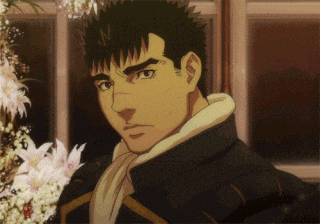 a man with a scarf around his neck stands in front of some flowers