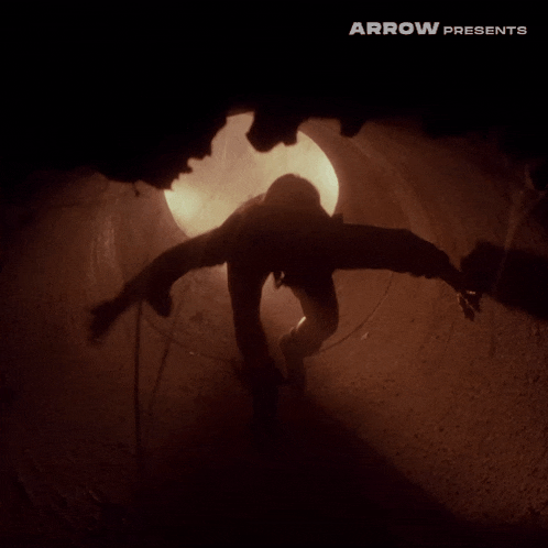arrow presents a silhouette of a person crawling through a tunnel