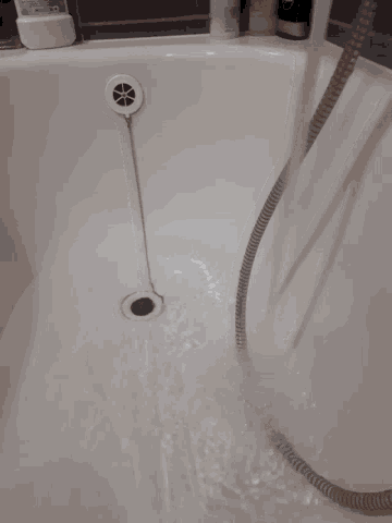 a bathtub with a hose coming out of it