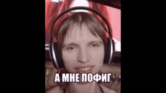 a woman wearing headphones is making a funny face in a foreign language .