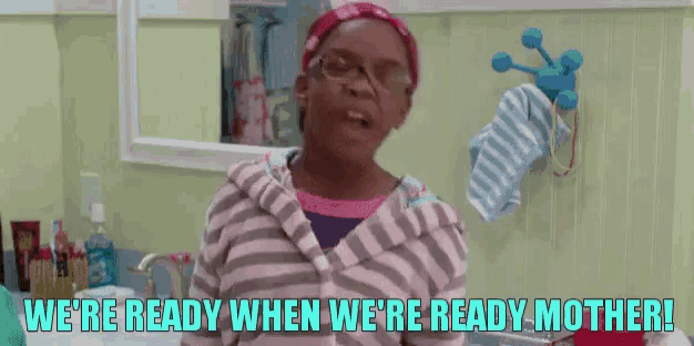 a woman in a bathroom with the words `` we 're ready when we 're ready mother '' .