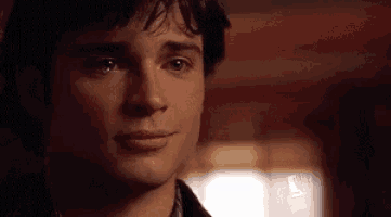 a close up of a man 's face with a tear running down his face .