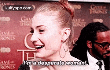 a woman is smiling and saying `` i 'm a desperate woman '' .