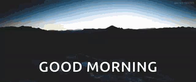 the sun shines brightly over the mountains and the words good morning