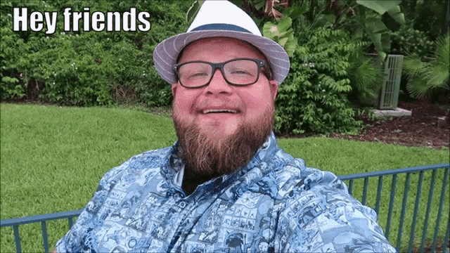 a man with a beard wearing glasses and a hat with the words hey friends below him