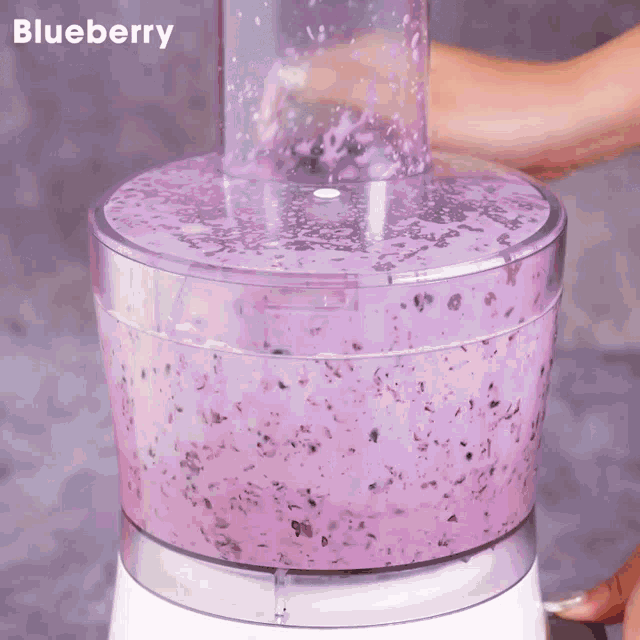 a blueberry smoothie in a blender with the word blueberry above it