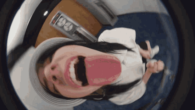a woman laying on a bed with her tongue hanging out