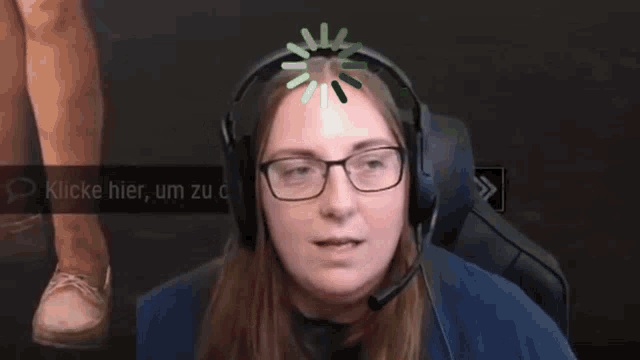 a woman wearing glasses and headphones is sitting in a chair and smiling .