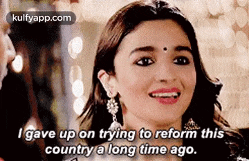 a woman is smiling and saying `` i gave up on trying to reform this country a long time ago '' .