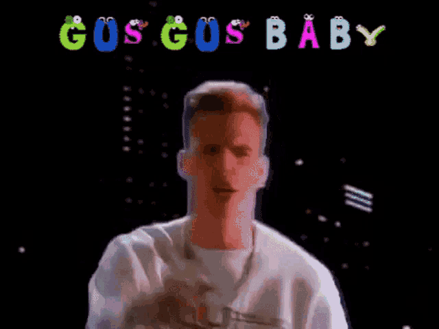 a man in a white shirt is dancing in front of a sign that says gus gus baby