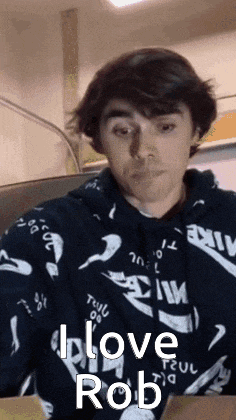 a young man wearing a hoodie with the words i love rob on it .
