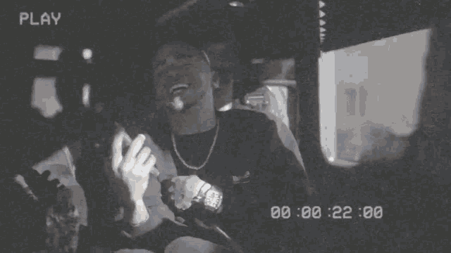 a black and white video of a man with the words play on the bottom