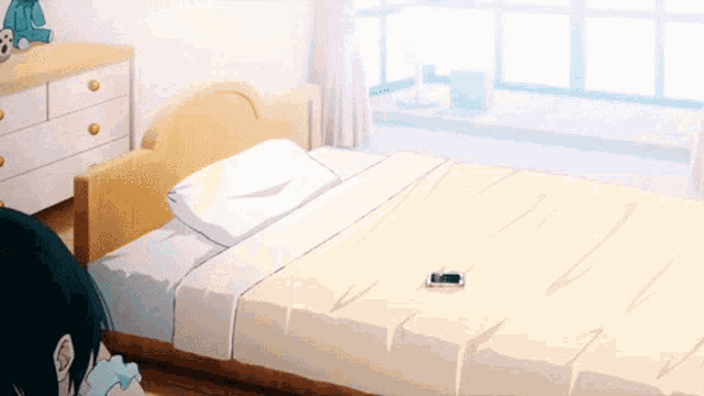 a bedroom with a bed and a dresser with a stuffed animal on it