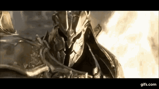 a close up of a knight in armor with a helmet on standing in front of a fire .