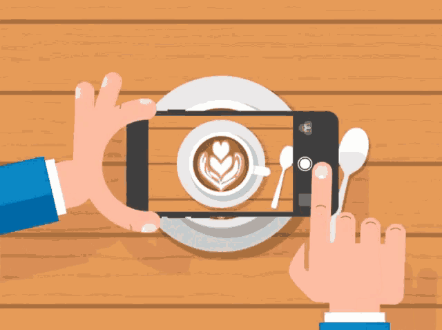 a person taking a picture of a cup of coffee on a plate