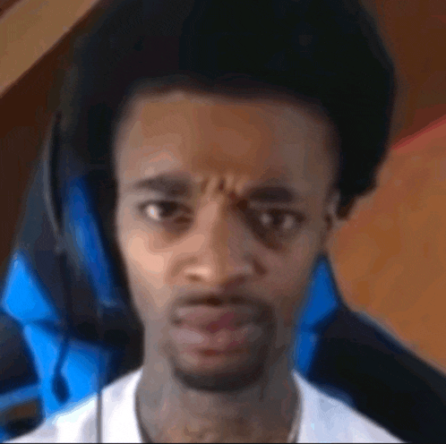 a man wearing headphones is making a funny face .