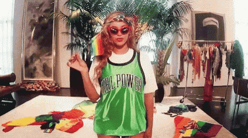 a woman wearing a green jersey that says girl power on it