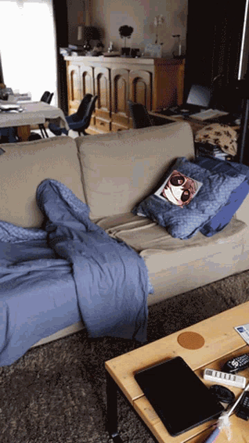 a couch in a living room with a pillow with a girl on it