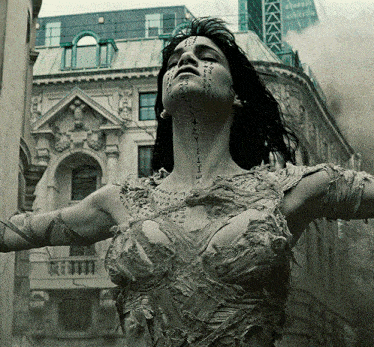 a woman in a mummy costume has chinese writing on her face and neck
