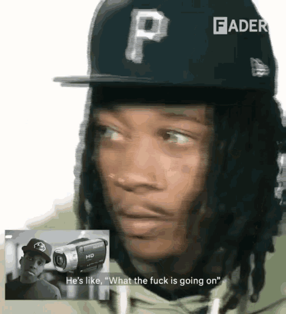 a blurry picture of a man wearing a hat with the letter p on it