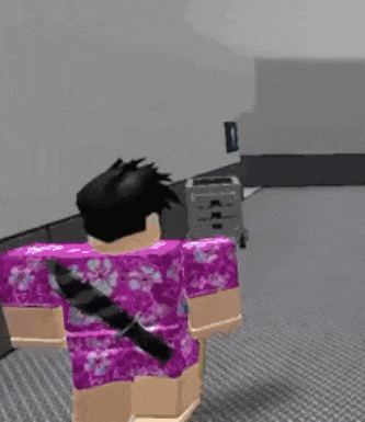 a person in a purple shirt is holding a knife in a room .