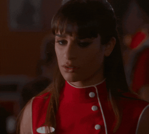 a woman in a red dress has a name tag on her chest that says ' maggie '