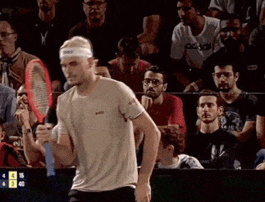 a tennis player wearing a headband that says asics on it