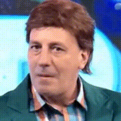 a close up of a man 's face with a green jacket on