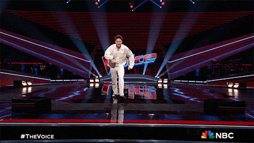 a man is dancing on a stage with the word nbc in the background