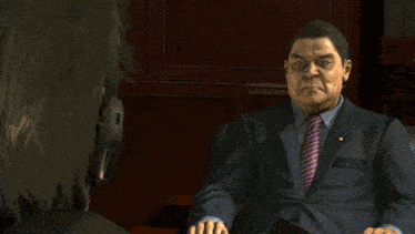 a man in a suit and tie holds his hands together