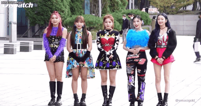 a group of girls are standing next to each other in front of a building with dispatch written on the bottom