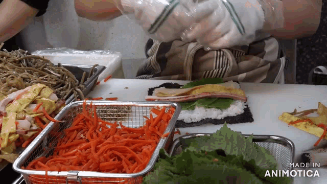 a person is making a sandwich with carrots and lettuce and says made in animotica on the bottom right