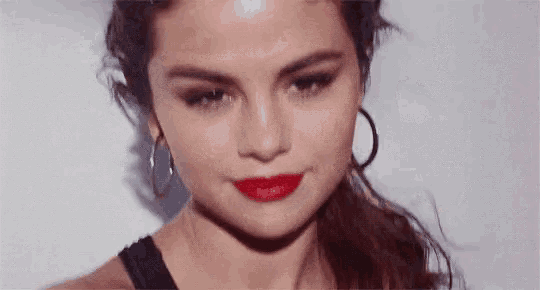 a close up of a woman 's face with red lipstick
