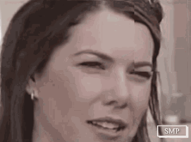 a close up of a woman 's face with a smp logo in the corner