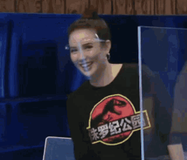 a woman wearing a t-shirt with a dinosaur on it