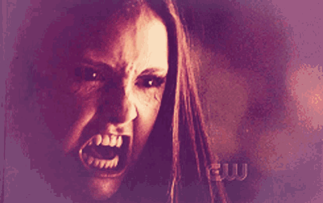 a close up of a woman 's face with a very angry expression