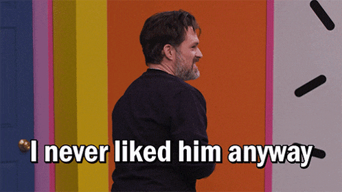 a man says i never liked him anyway in front of a rainbow wall