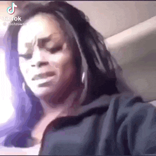 a woman is sitting in a car with her eyes closed .