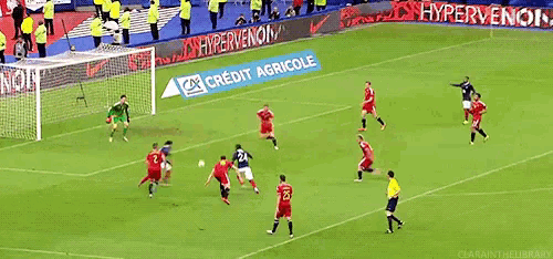 a group of soccer players are playing on a field with an ad for credit agricole in the background