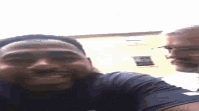two men are taking a selfie with each other and smiling .