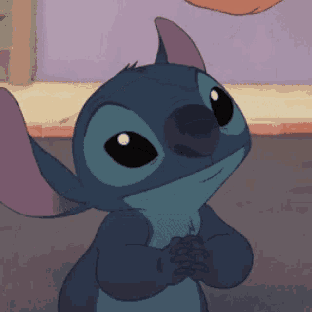 a close up of a stitch cartoon character with its hands folded
